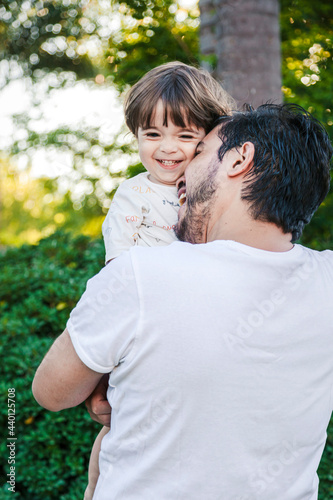 Happy father embracing son at back yard