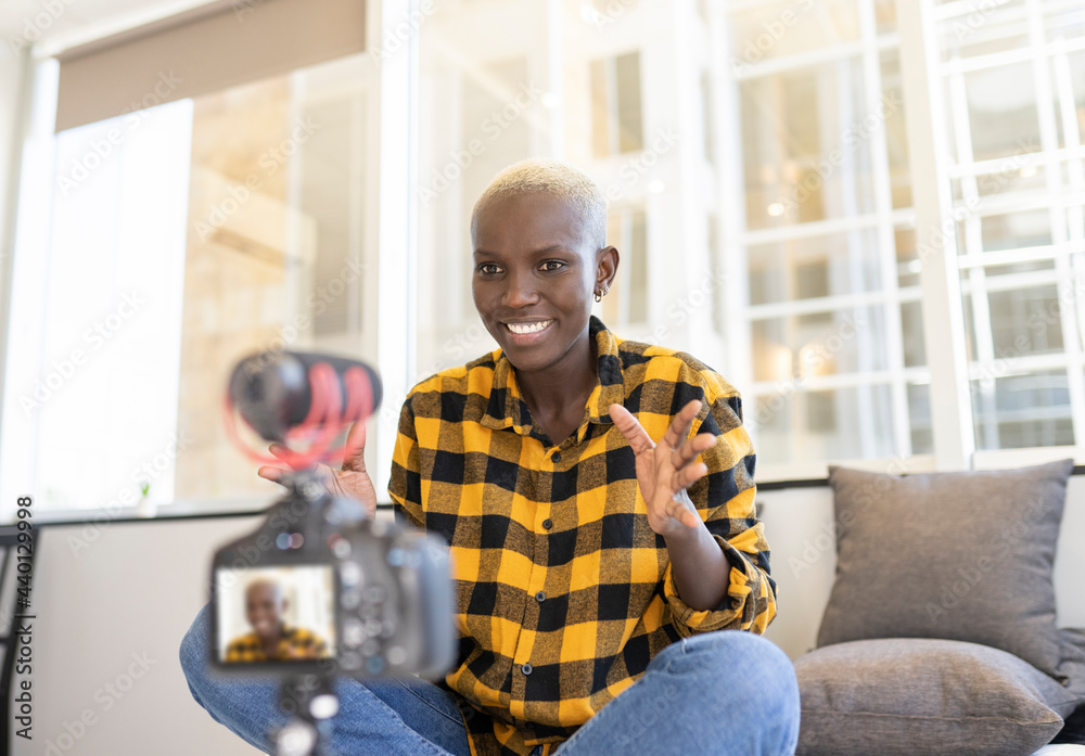 Smiling influencer gesturing while vlogging at home Smiling influencer gesturing while vlogging at home