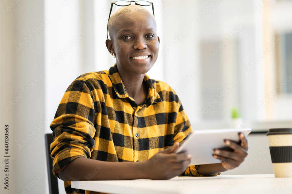 Smiling businesswoman holding digital tablet at home Smiling businesswoman holding digital tablet at home