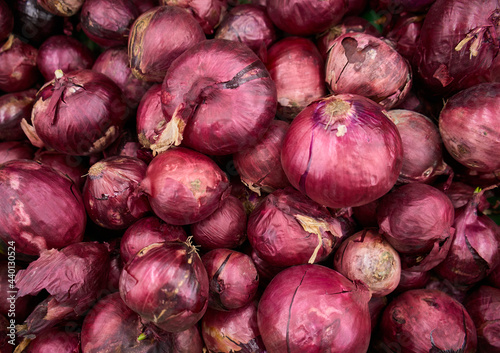 Red onions background. A pile of red onions as a background. Full Frame Shot Of Purple Onions. Fresh whole purple onions. 