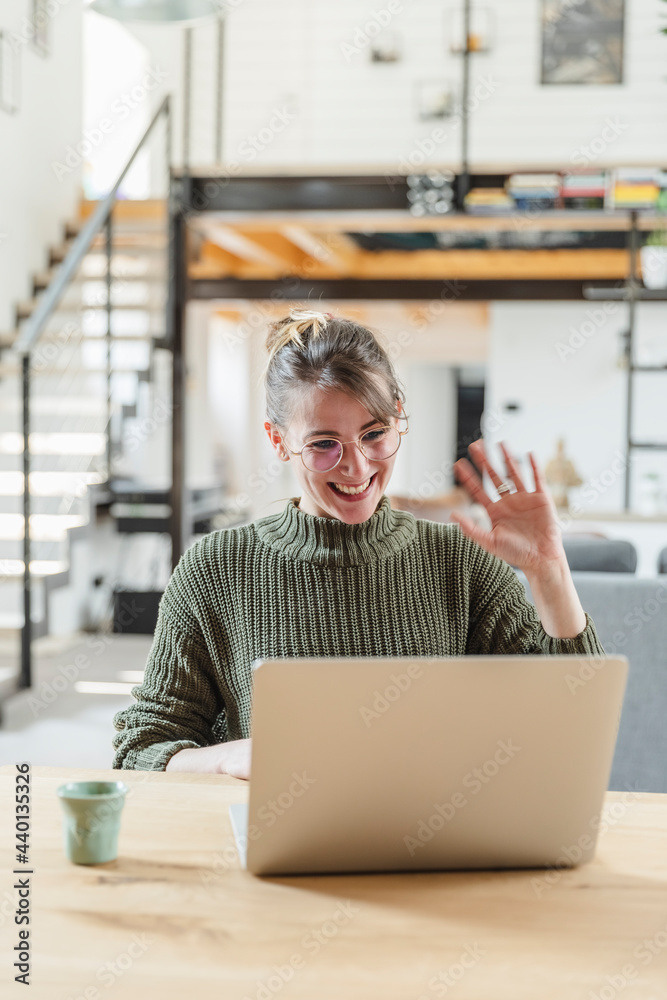© 27exp/Westend61 - Female entrepreneur waving during video call on laptop at home © 27exp/Westend61 - Female entrepreneur waving during video call on laptop at home