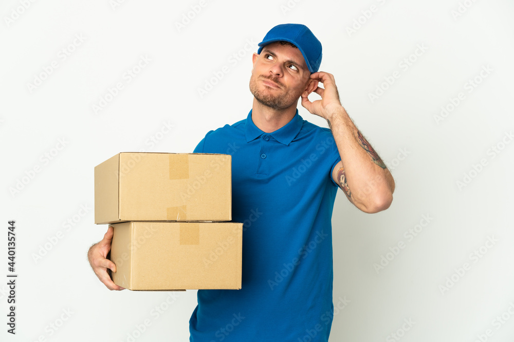Delivery caucasian man isolated on white background having doubts Delivery caucasian man isolated on white background having doubts