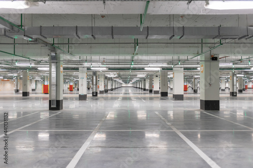 Light gray underground parking without cars, free and empty.