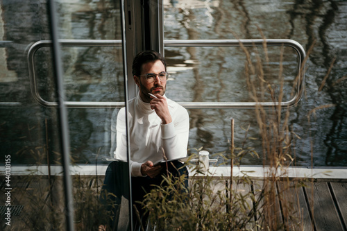 Thoughtful male professional working at houseboat