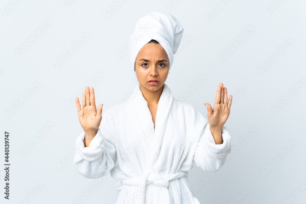 Young woman in bathrobe over isolated white background making stop gesture and disappointed Young woman in bathrobe over isolated white background making stop gesture and disappointed