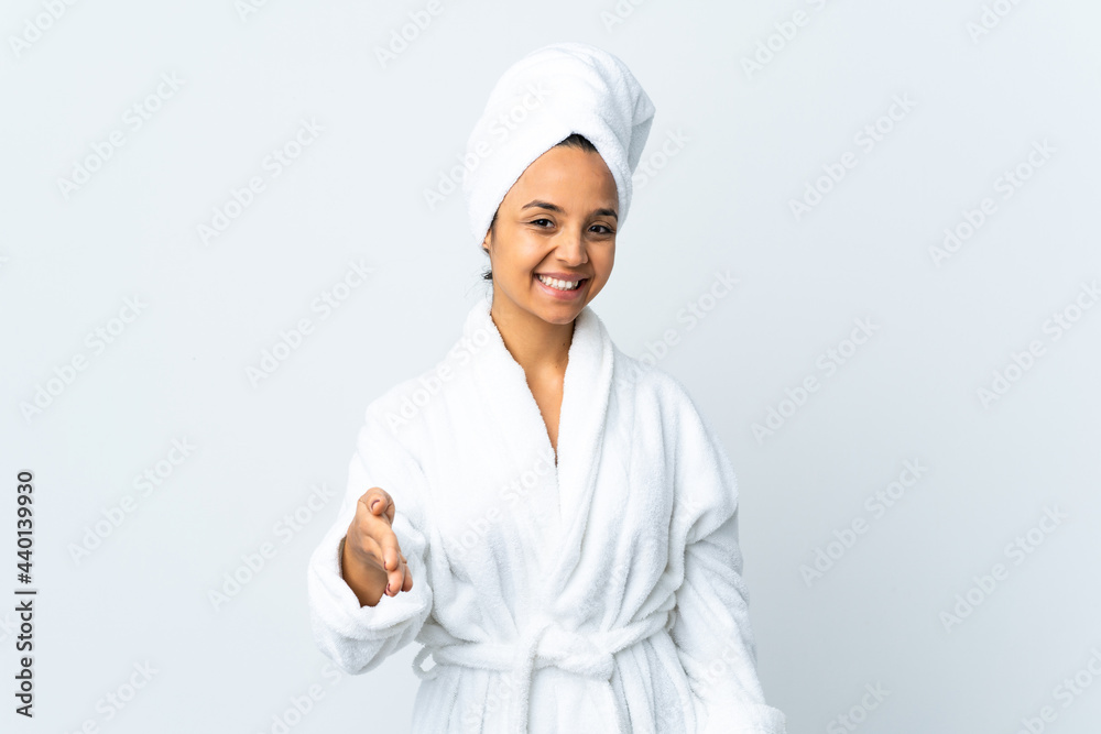Young woman in bathrobe over isolated white background shaking hands for closing a good deal Young woman in bathrobe over isolated white background shaking hands for closing a good deal