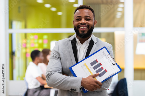 Young businessman with document paper on clipboard at office