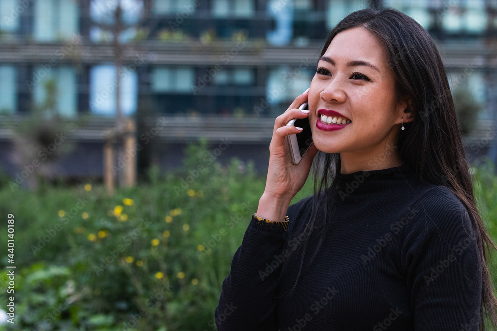 Smiling young woman looking away while talking on smart phone Smiling young woman looking away while talking on smart phone