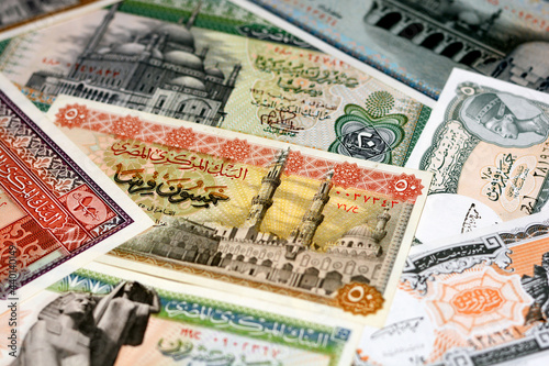 Selective focus for a collection of old Egyptian money banknotes, Leftover Egyptian pounds currency non circulating anymore,  20, 10 and 5 Pounds with 50, 25, 10 and 5 piasters, vintage retro. photo