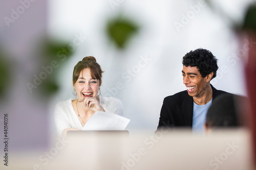 Cheerful male and female colleagues at office