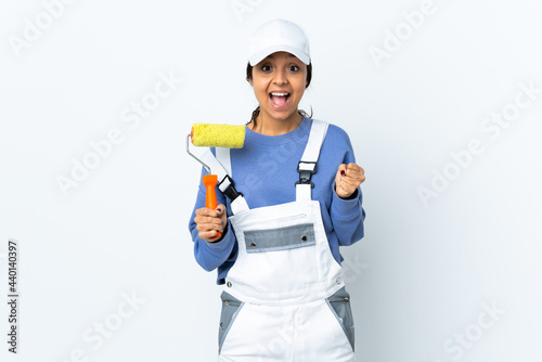 Painter woman over isolated white background celebrating a victory in winner position © luismolinero