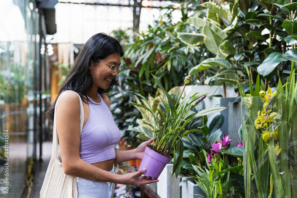 Woman holding potted plant at nursery Woman holding potted plant at nursery