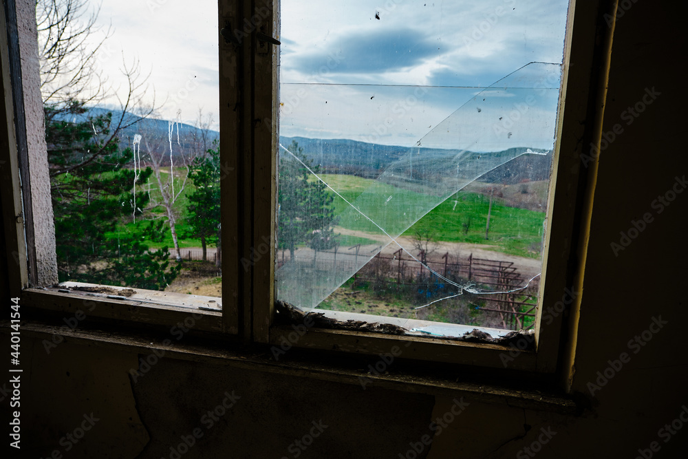 Fototapeta premium Bulgaria and views from cute and small villages during bright day.Vintage window and dirty glass seen outside of small village view. 