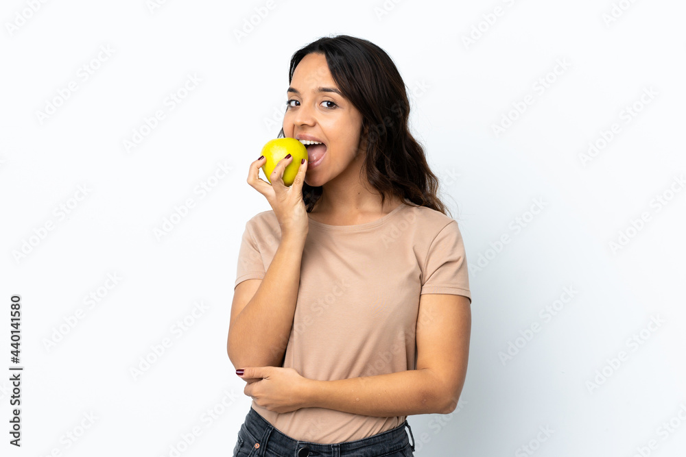 Young woman over isolated white background eating an apple Young woman over isolated white background eating an apple