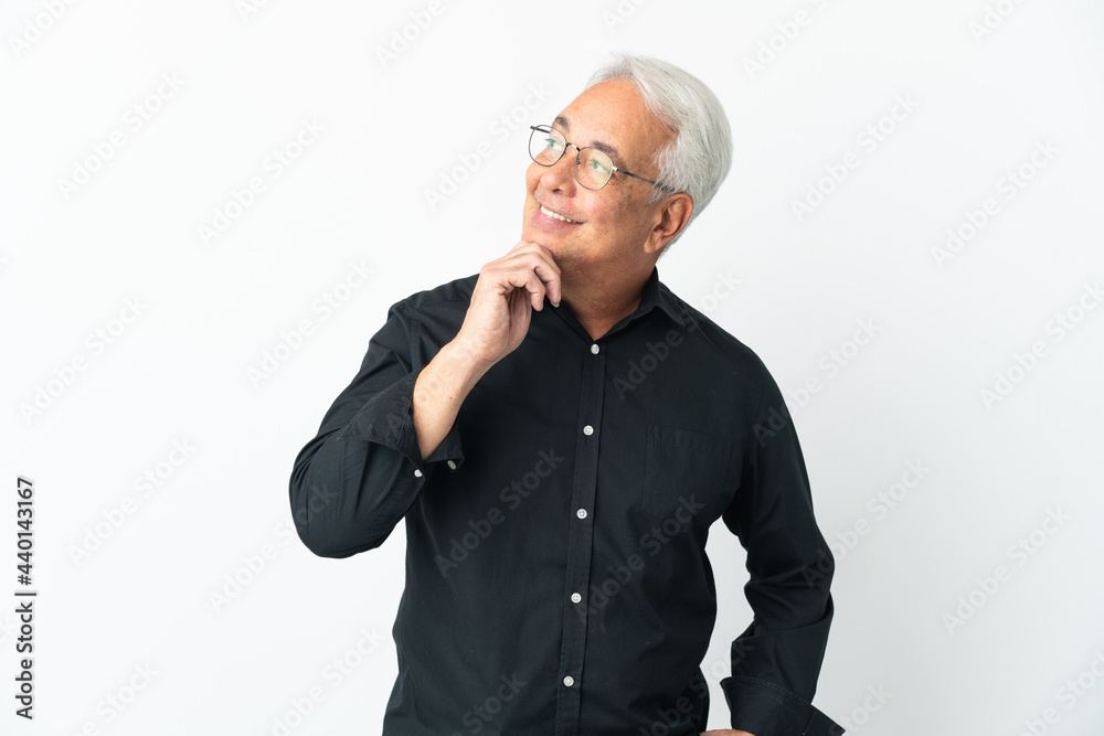 Middle age Brazilian man isolated on white background looking up while smiling Middle age Brazilian man isolated on white background looking up while smiling