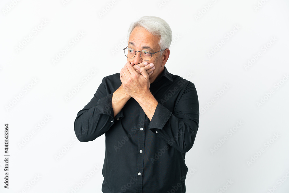 Middle age Brazilian man isolated on white background covering mouth and looking to the side Middle age Brazilian man isolated on white background covering mouth and looking to the side