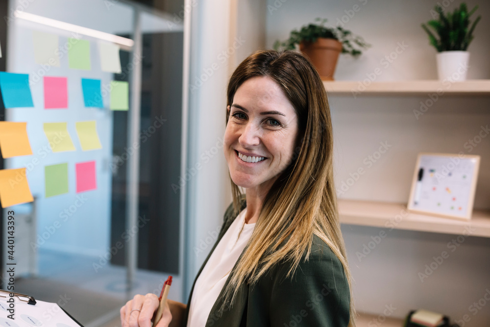 Confident businesswoman planning strategy at office Confident businesswoman planning strategy at office