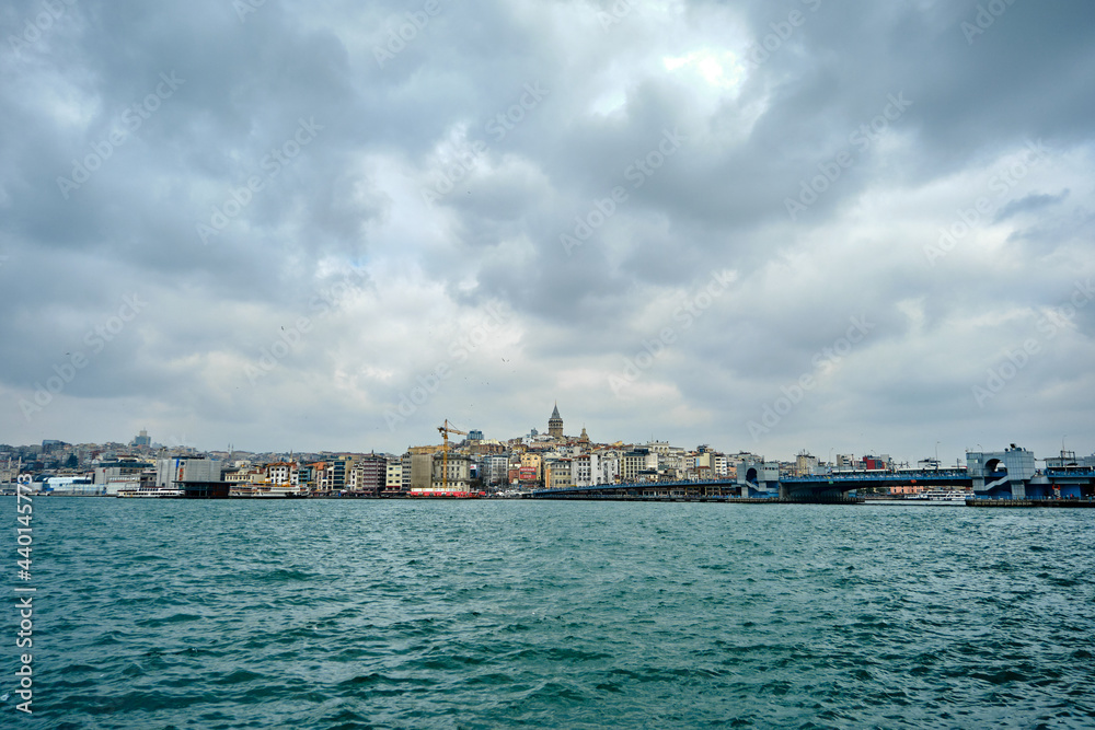 03.03.2021. istanbul turkey. Golden horn (halic) photo in istanbul by photo from eminonu during overcast and rainy day.Architectural details of apartments and galata tower and bridge looking bosporus 