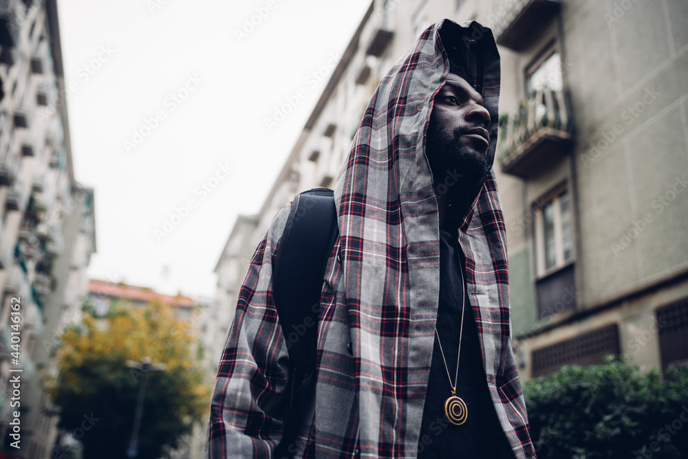 Man wearing hooded jacket looking away Man wearing hooded jacket looking away