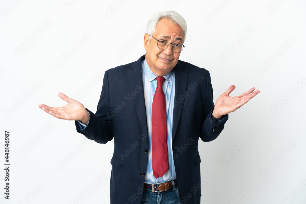 Middle age Brazilian business man isolated on white background having doubts while raising hands Middle age Brazilian business man isolated on white background having doubts while raising hands