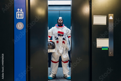 Male astronaut standing in elevator photo