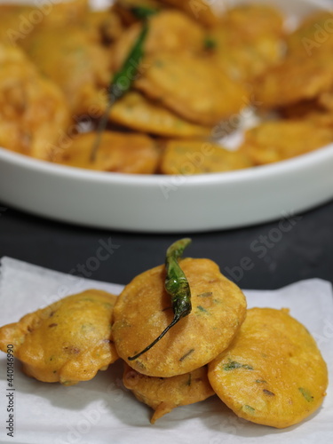 Vegan Aloo Pakora, Aloo Pakoda, Potato Fritters a thin slice of Potato dipped in Gram flour with spices and deep fried.