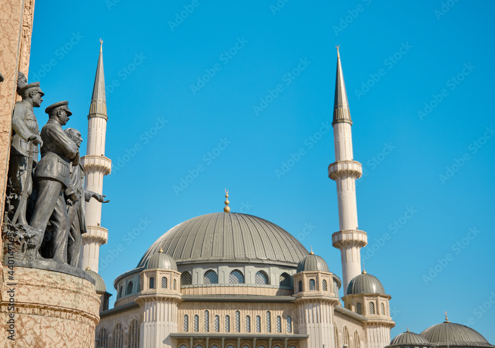 Turkey istanbul. Center of taksim square during morning with details of taksim, republic monument (cumhuriyet aniti) and recently constructed taksim mosque with blue sky