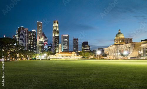 Singapore, Padang field at dusk with illuminated city skyline in background photo