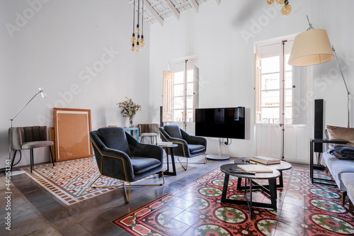 Interior of loft apartment with furniture and tiled floor photo