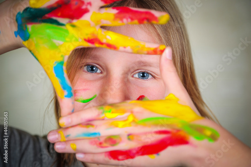 Happy child girl artist with brushes and palette in hands on white background. Painting education concept  art school