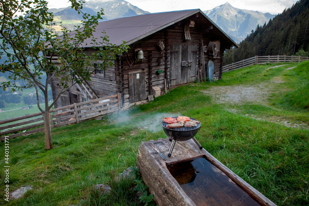 Barbecue grill outside wooden hut at Mayrhofen, Zillertal, Austria Barbecue grill outside wooden hut at Mayrhofen, Zillertal, Austria