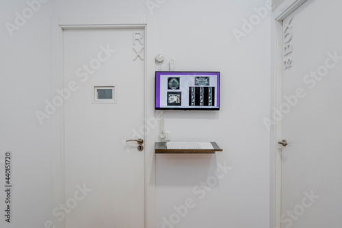 Closed doors by flat screen at medical clinic