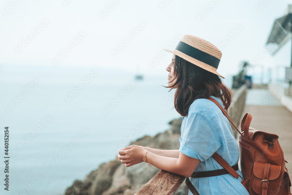 young pretty woman walking by sea quay