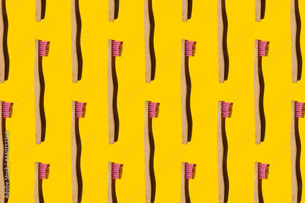 Digitally generated pattern with bamboo toothbrushes on yellow background