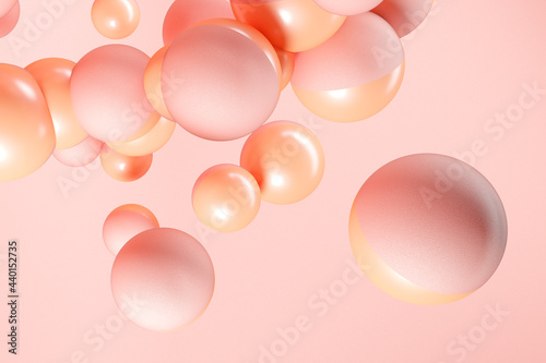 Three dimensional render of pink and orange spheres floating against pink background photo
