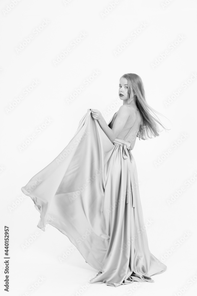 black and white frame. a girl in a wedding dress fluttering in the wind. flying fabric