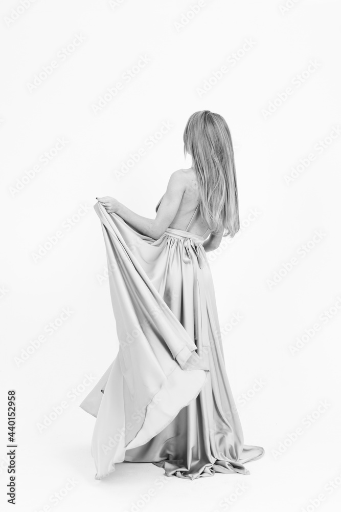 black and white frame. a girl in a wedding dress fluttering in the wind. flying fabric black and white frame. a girl in a wedding dress fluttering in the wind. flying fabric