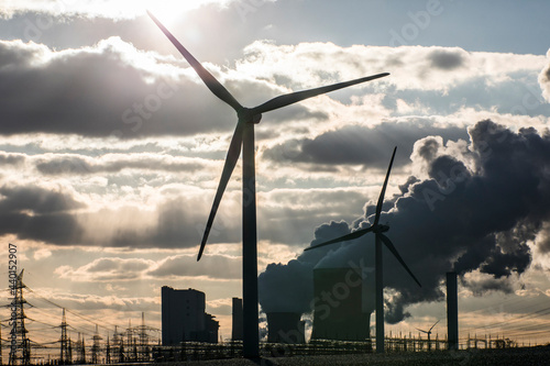 Germany, North Rhine Westphalia, Niederaussem, Wind turbine with lignite power plant in background