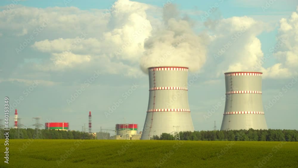 Nuclear power plant, Cooling tower of nuclear power plants. Industrial zone with steam emission into the air atmosphere. Republic of Belarus, a station on the border with Lithuania. Nuclear power plant, Cooling tower of nuclear power plants. Industrial zone with steam emission into the air atmosphere. Republic of Belarus, a station on the border with Lithuania.