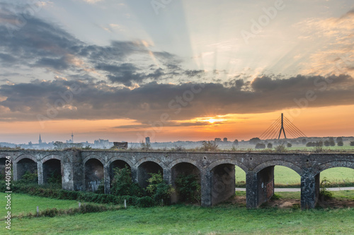 Germany, North Rhine-Westphalia, Wesel, Old viaduct at moody sunrise