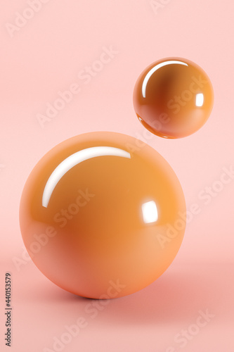 Three dimensional render of two orange glossy spheres against pink background