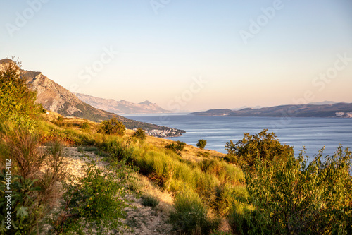 Sunlight over mountains near Adriatic sea in Omis, Dalmatia, Croatia