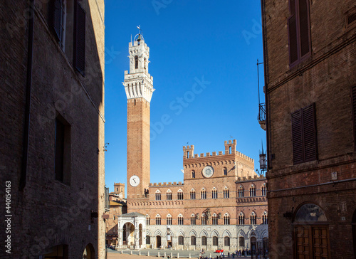Italy, Tuscany, Siena, Clear sky over Palazzo Pubblico and Torre del Mangia photo