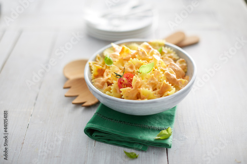 Bowl of pasta salad lying on top of folded napkin
