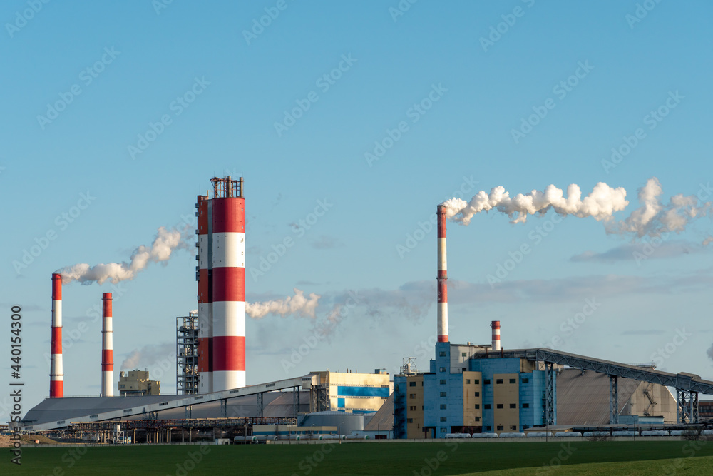 Industrial zone. A large enterprise for the production of chemical and mineral fertilizers and pesticides. White smoke or steam escapes from a large chimney.