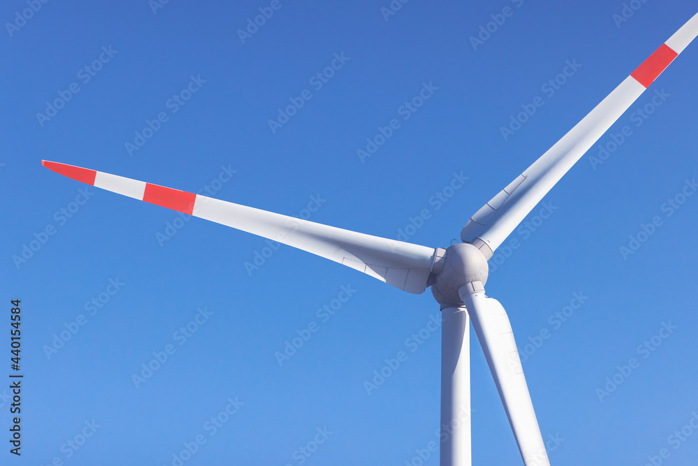 Wind turbine standing against clear blue sky Wind turbine standing against clear blue sky