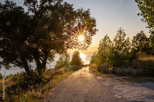 Empty road with sunset over Adriatic sea in Omis, Dalmatia, Croatia photo