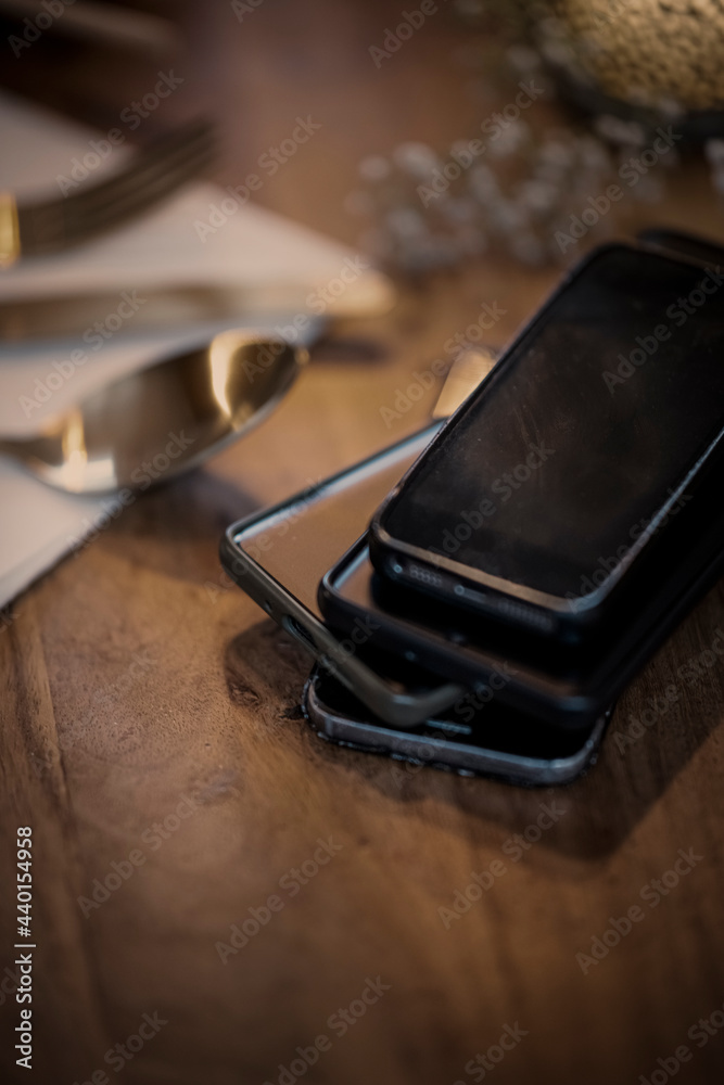 Smart phone stacked on dining table at home Smart phone stacked on dining table at home