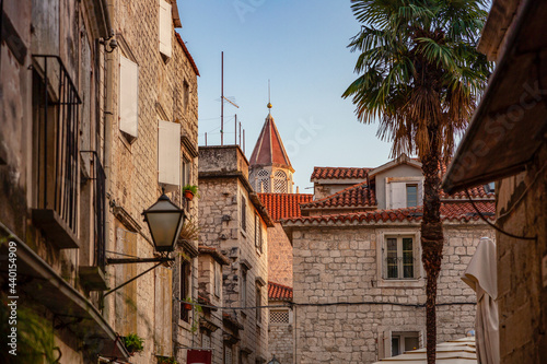 Croatia, Split-Dalmatia County, Trogir, Old town houses with bell tower of Church of Saint Nicholas in background photo