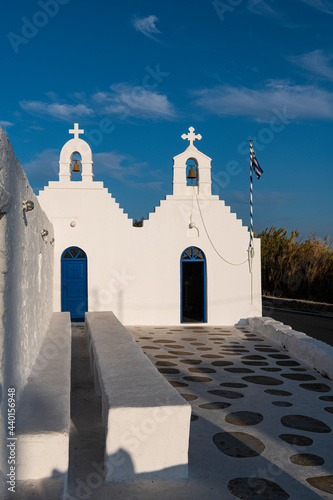 Empty footpath by white church in Mykonos, Greece photo